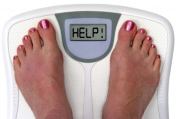 Feet on a weight scale that reads "Help!"